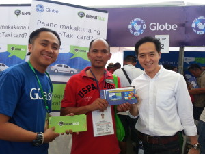 G-Xchange, Inc. Sales Issuance Director Albert Antig (right) with one of the first taxi drivers to enjoy the new GCash GrabTaxi Card