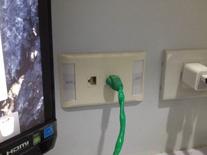 Patch cord connected to a data outlet jack.