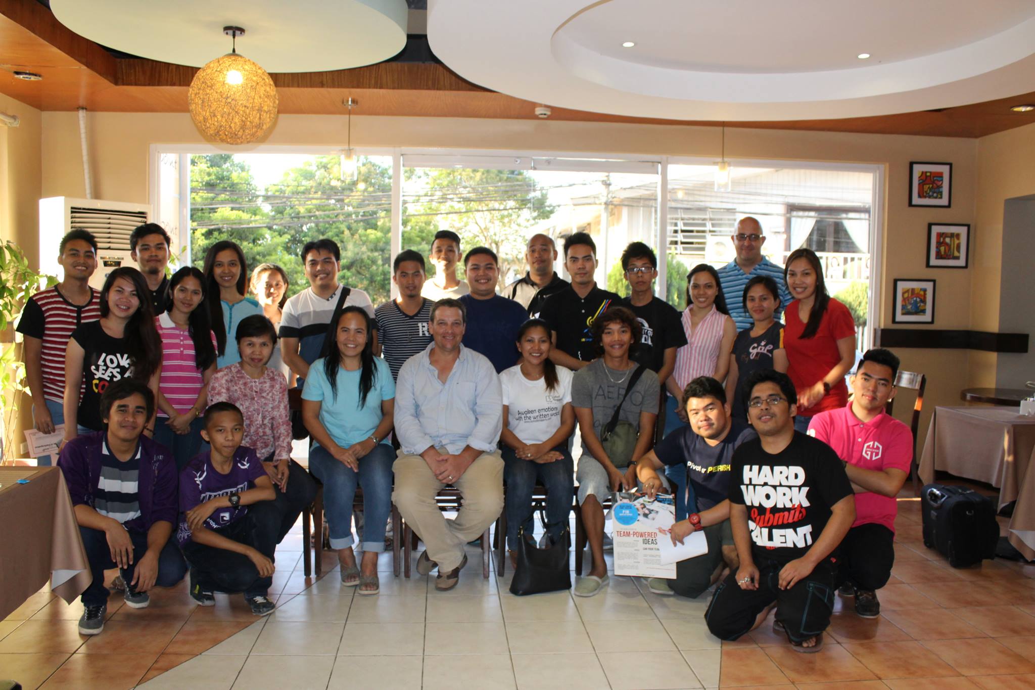 Resource person Mark Phillips, cofounder of Gwion, a local startup, pose with the participants to the Writeshop event.