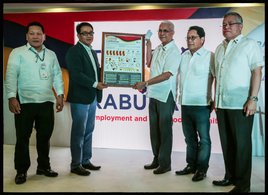 NEW GOVERNMENT BLUEPRINT FOR DECENT EMPLOYMENT. The “Trabaho, Negosyo at Kabuhayan: A Blueprint for Decent Employment and Entrepreneurship 2017-2022” prioritizes decent job creation, entrepreneurship, creativity and innovation, formalization and growth of micro, small, and medium-sized enterprises (MSMEs), youth unemployment reduction, education and training. The Blueprint was signed by Secretaries Ramon Lopez (rightmost) of the Department of Trade and Industry (DTI) and Silvestre Bello III (4th from L) of the Department of Labor and Employment (DOLE) at the Trabaho, Negosyo at Kabuhayan (TNK)-Employment and Livelihood Summit on 2 December in Taguig. The Blueprint, which was presented to Cabinet Secretary Leoncio Evasco Jr. (3rd from L), envisions full employment at 5% unemployment rate by creating 7.5 million jobs, by 2022, mainly in key employment generating sectors (KEGS) such as manufacturing including food processing, construction, tourism, Information Technology-Business Process Management (IT-BPM), transportation and logistics, and retail trade. Also shown here are DOLE Undersecretary Dominador Say (leftmost) and DTI Undersecretary Rowel Barba (2nd from L), who both chaired the Summit’s breakout sessions on livelihood and employment.